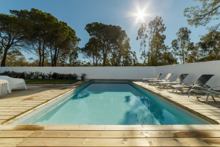Modern house with garden swimming pool and wooden deck